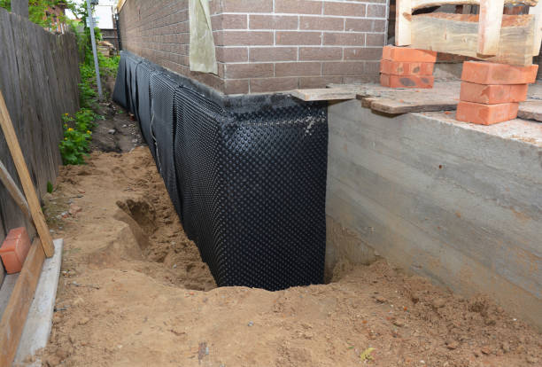 Happy homeowners after waterproofing job in Wolflake